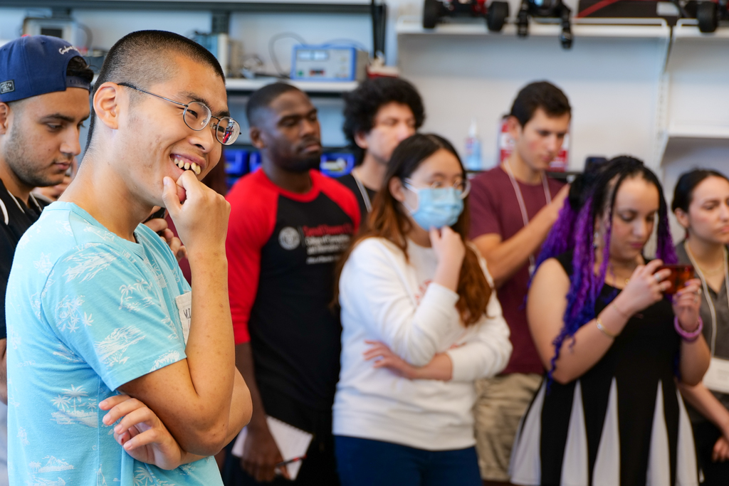 Images of SoNIC students programming, watching demos, walking in the halls, and attending class.