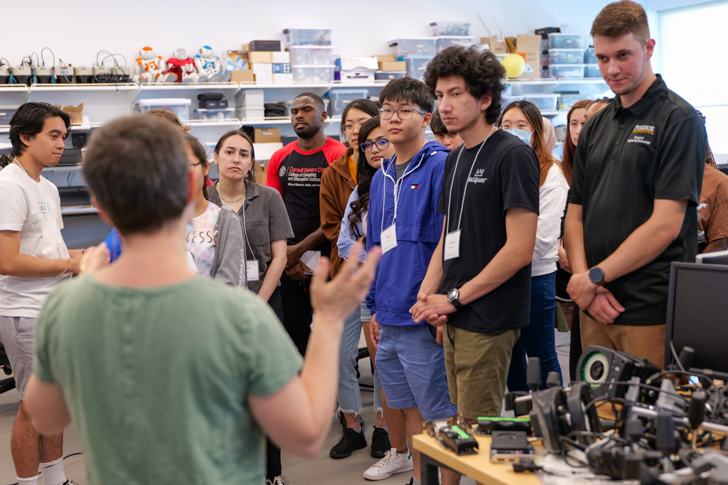 Images of SoNIC students programming, watching demos, walking in the halls, and attending class.