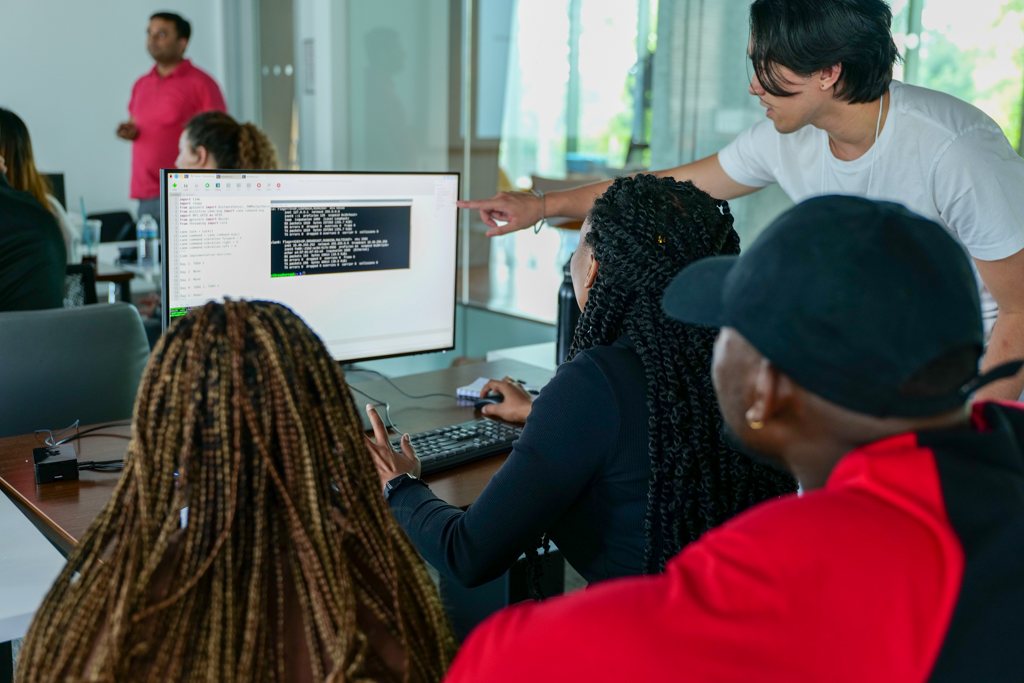 Images of SoNIC students programming, watching demos, walking in the halls, and attending class.