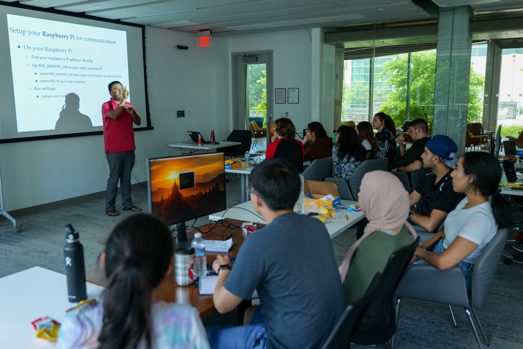 Images of SoNIC students programming, watching demos, walking in the halls, and attending class.